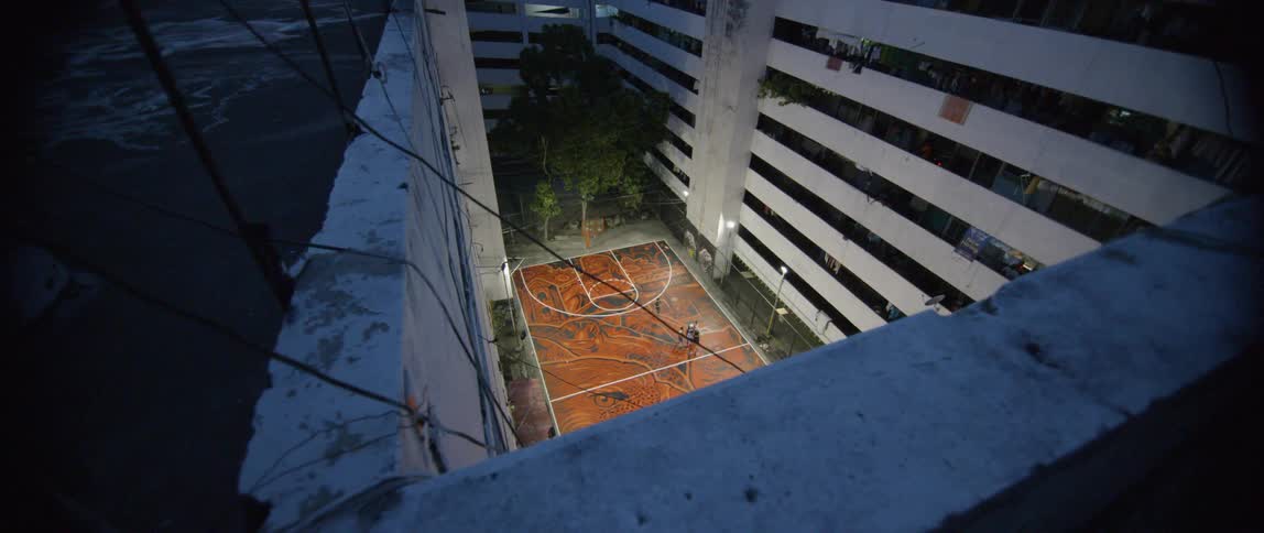A basketball court sits in an apartment courtyard