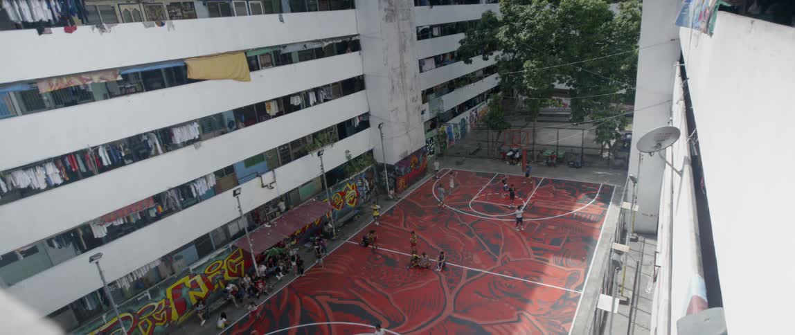 People on a basketball court on a sunny day