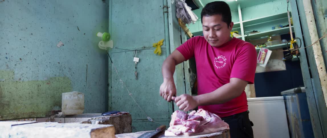 Man butchers a piece of meat