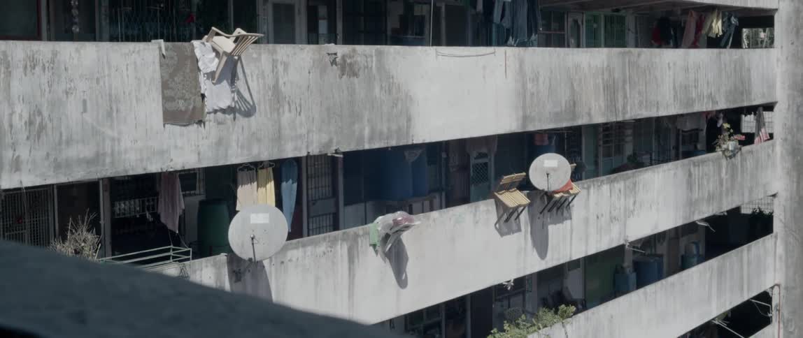 Clothes blow in the breeze as they hang in the balconies