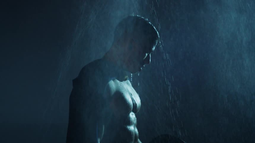 Rain falls on a shirtless man