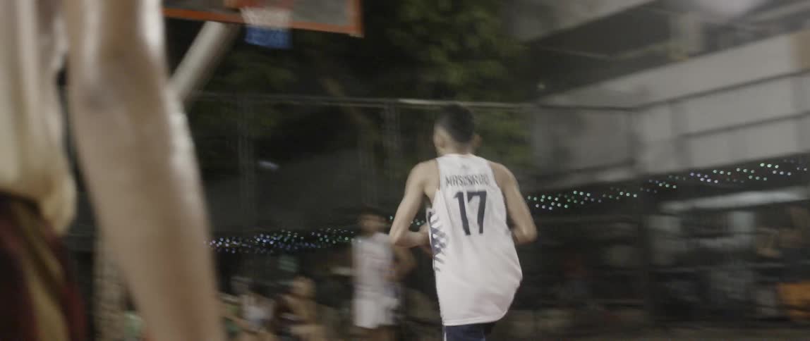 Man dribbles a basketball and shoots it into a hoop