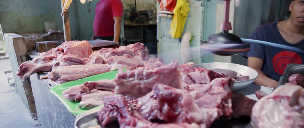 Meat sits on trays in a butcher shop