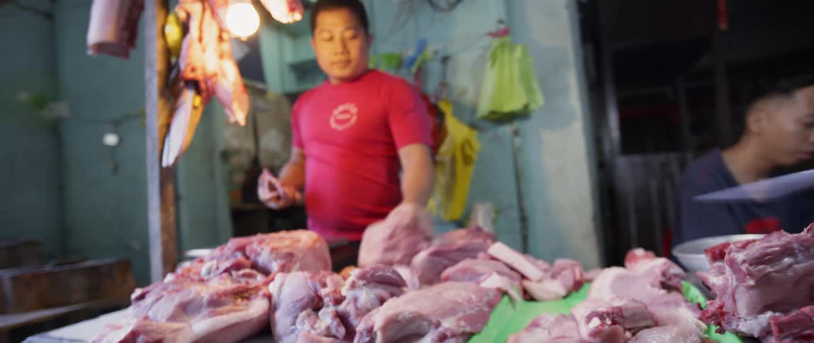 A man works in a butcher shop