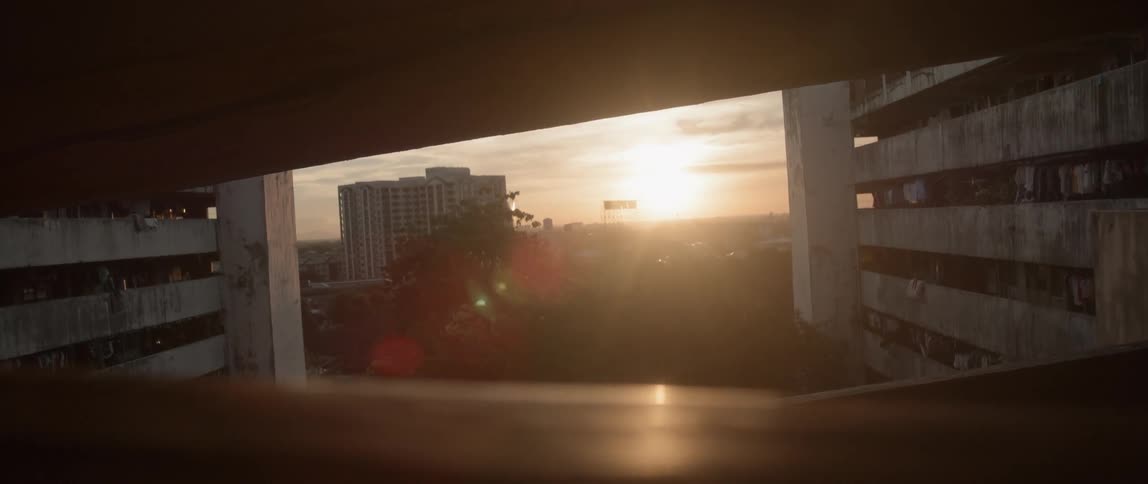 The sun sets in a city