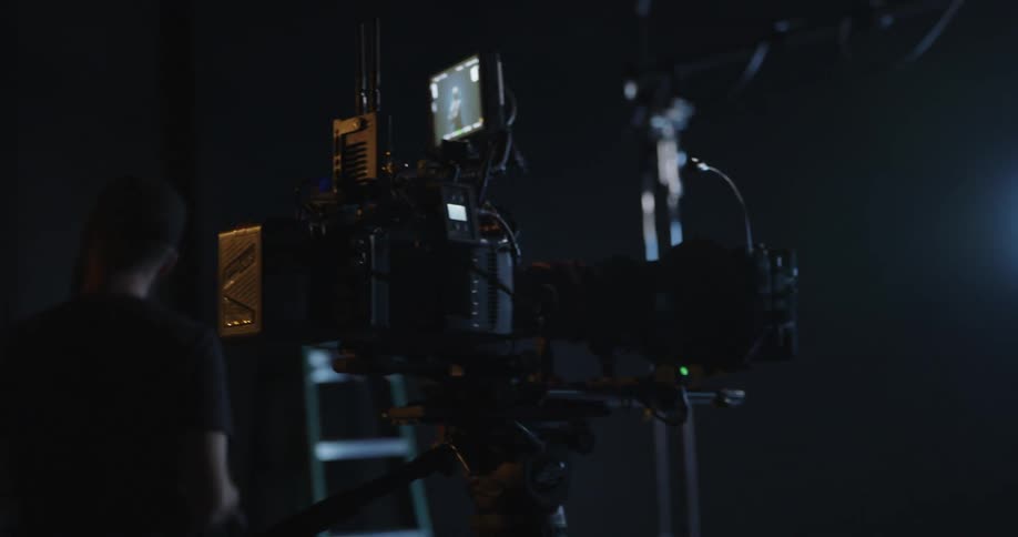 Cameras are filming a man walking through a room in daylight