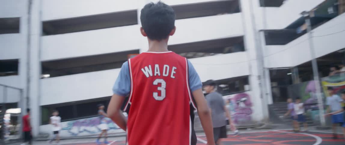 Child dribbles a basketball on a court