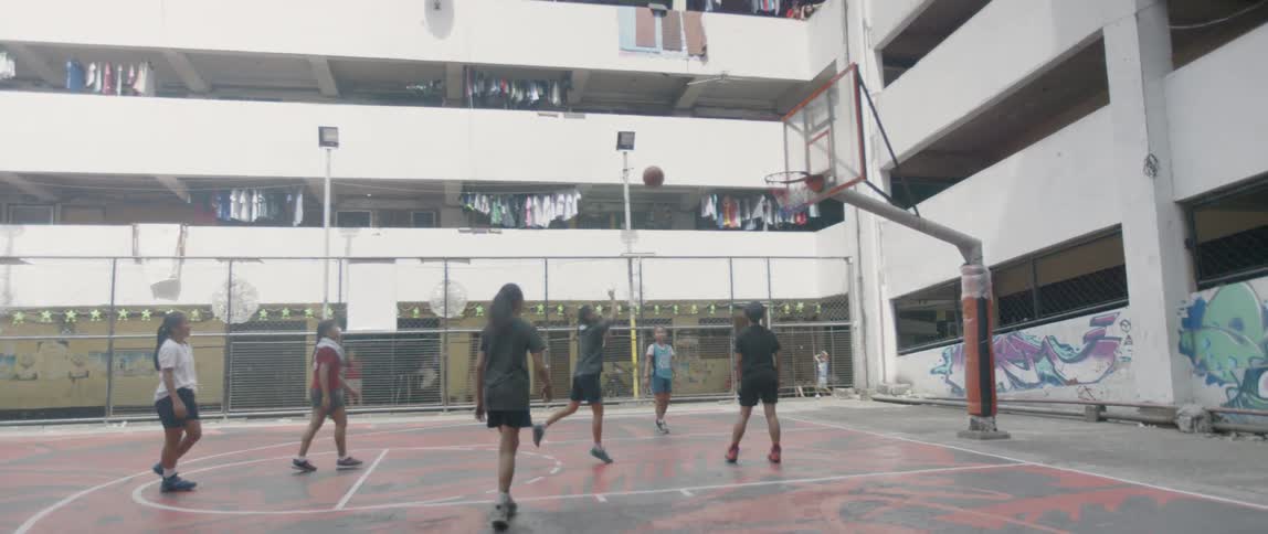Young kids play basketball together