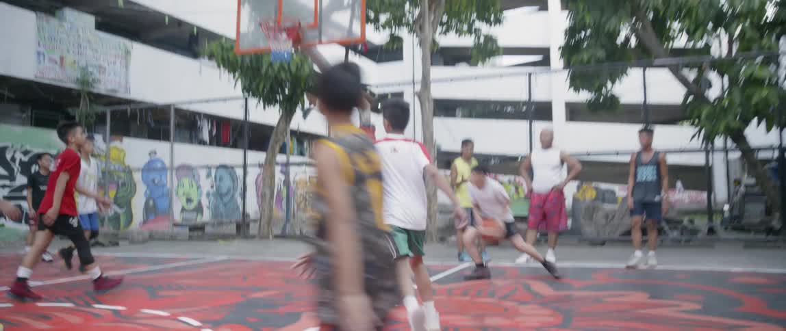 Kids play basketball on an outdoor court