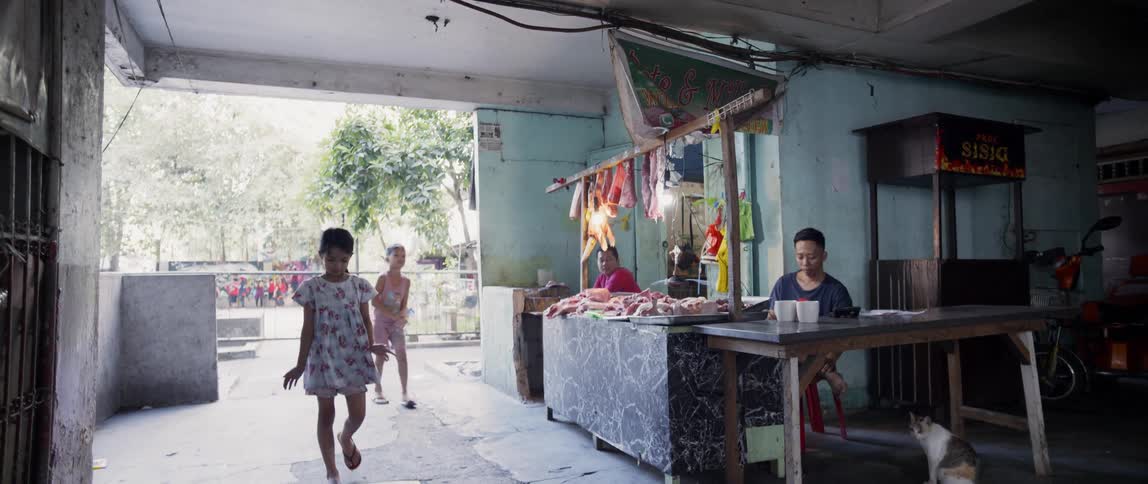 Children are playing inside a shop in an asian country in daylight