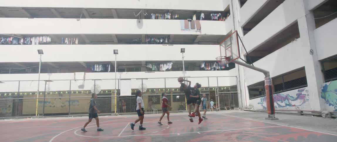 Group of young women play basketball on a court