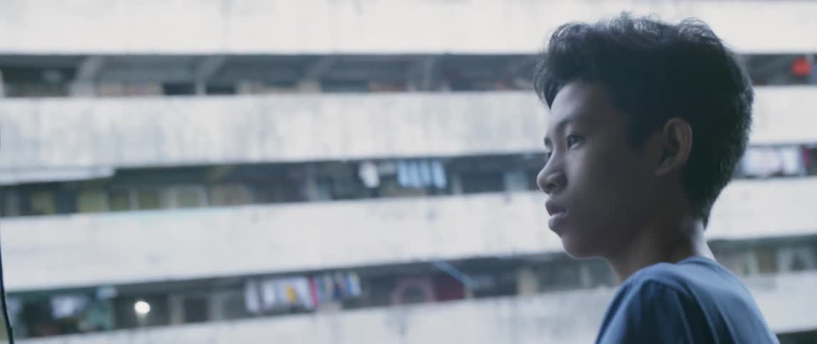 Boys stands new crowded apartments