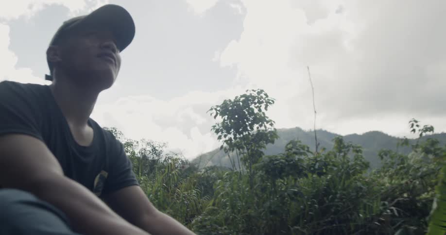 Man rides along a road in a mountainous area