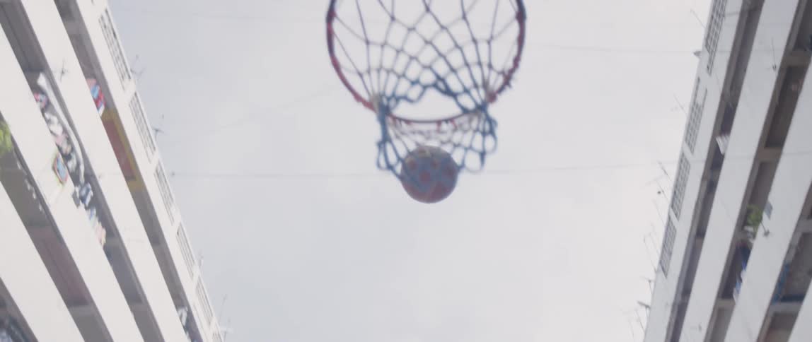 A basketball is thrown through a basketball hoop