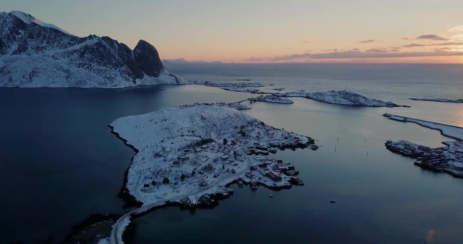 Snow covered land sits surrounded by water