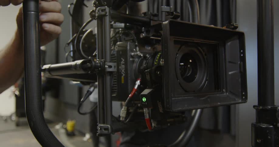 A cameraman works on his camera rig