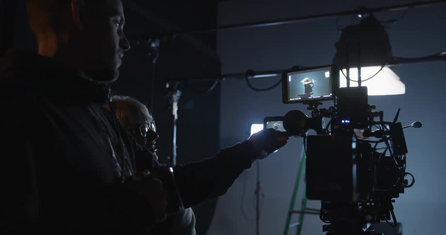 Men film in a dark studio