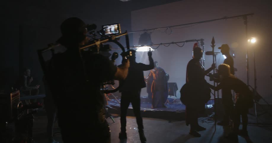 A director is stopping the action as a crew films on a set