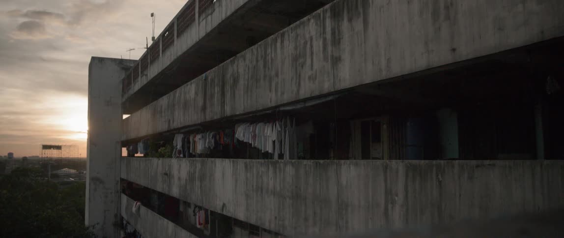 Clothing hang in the balconies of a large building