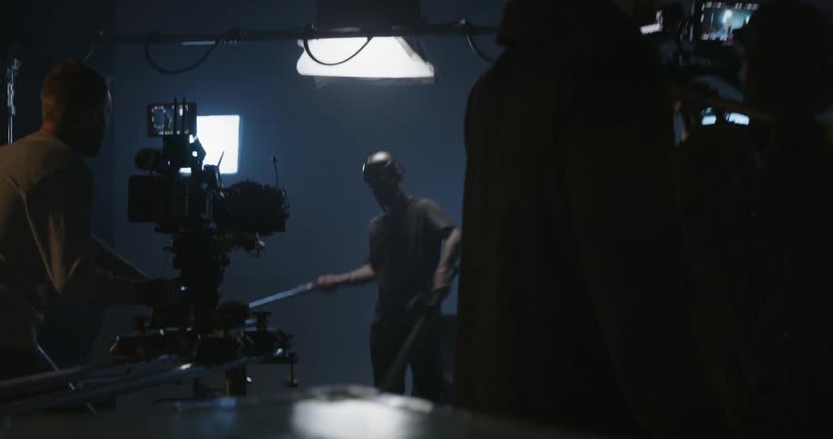 Man video records another man swinging swords