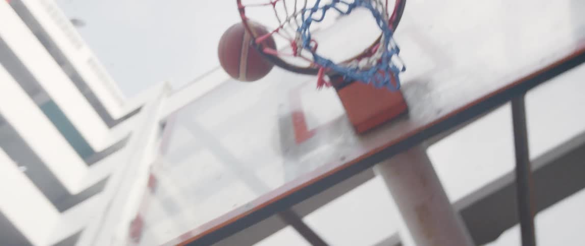 A girl throws a basketball and scores