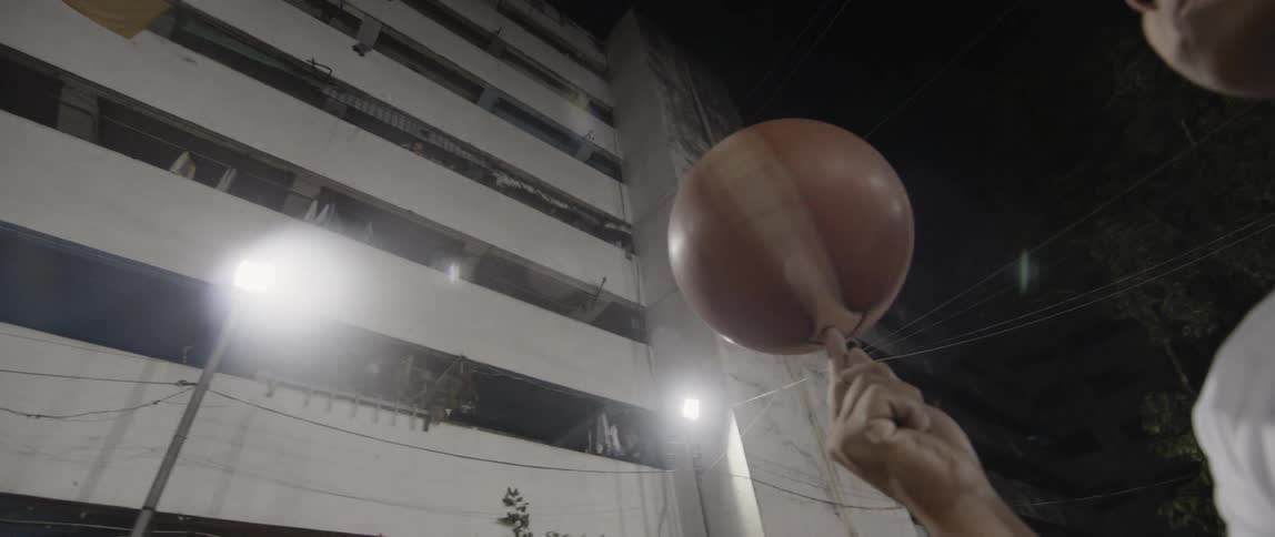 Person spins basketball on fingertip