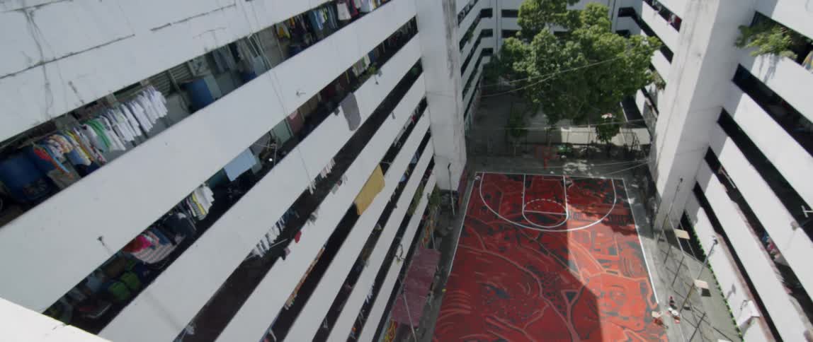 Large concrete building with clothes hanging up on the balcony