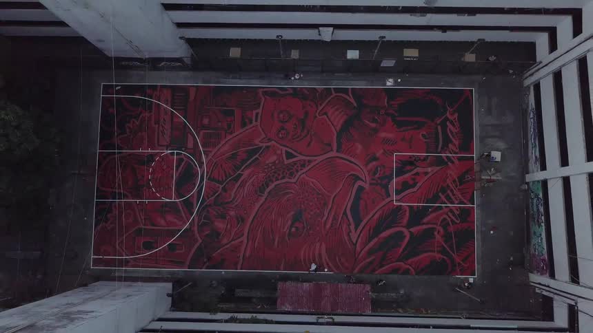 A basketball court sits in an apartment courtyard