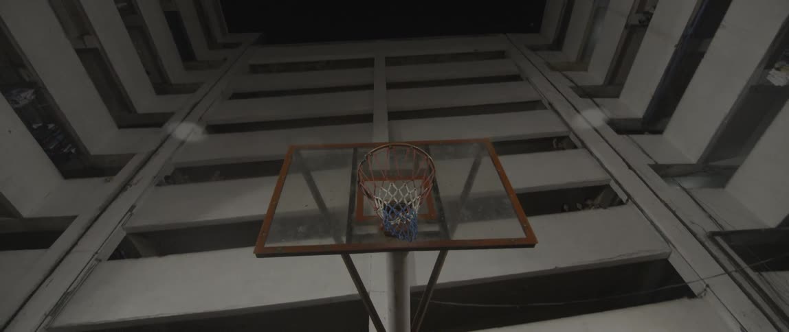A basketball hoop stands in a courtyard