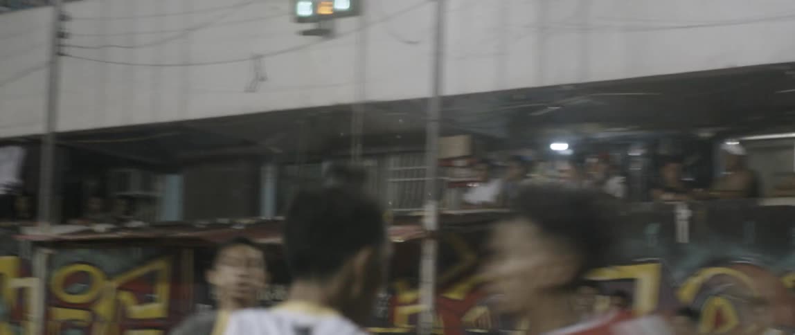 Men play basketball and one shoots a basket