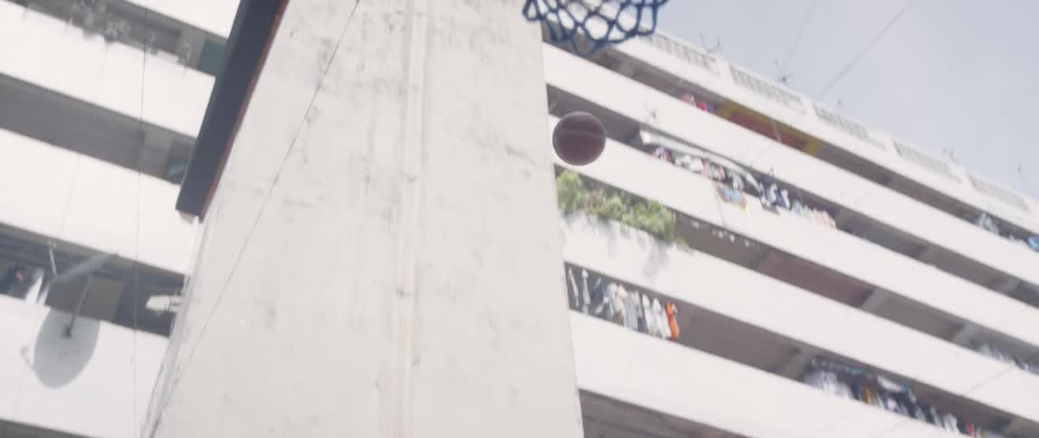 A boy shoots a basketball outside