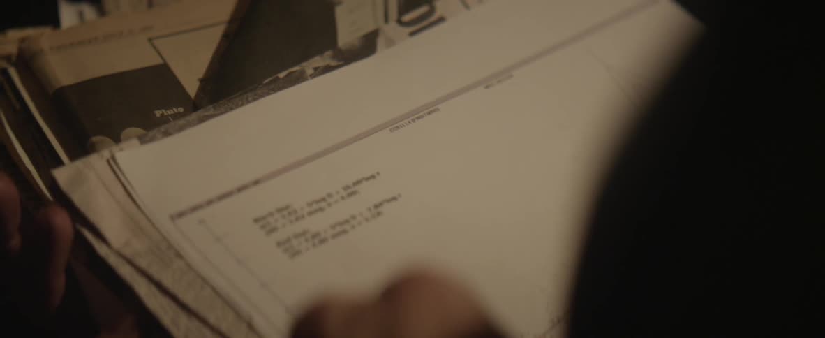 A person looking through a pile of images and papers