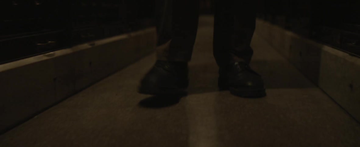 Person walking down a narrow dark hall