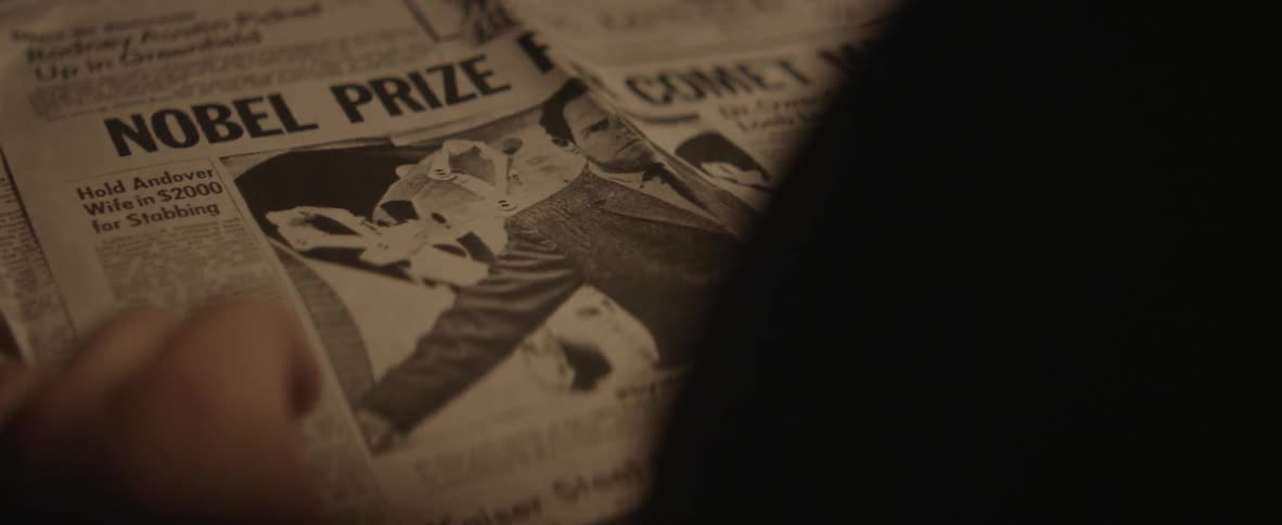 Person flipping through a newspaper