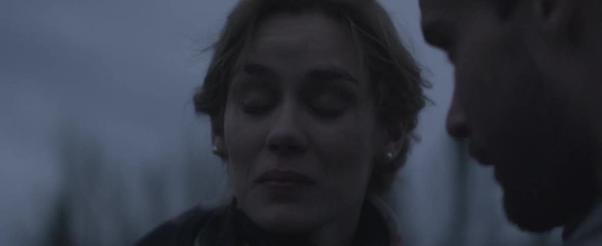 Man speaks to a woman who looks sad