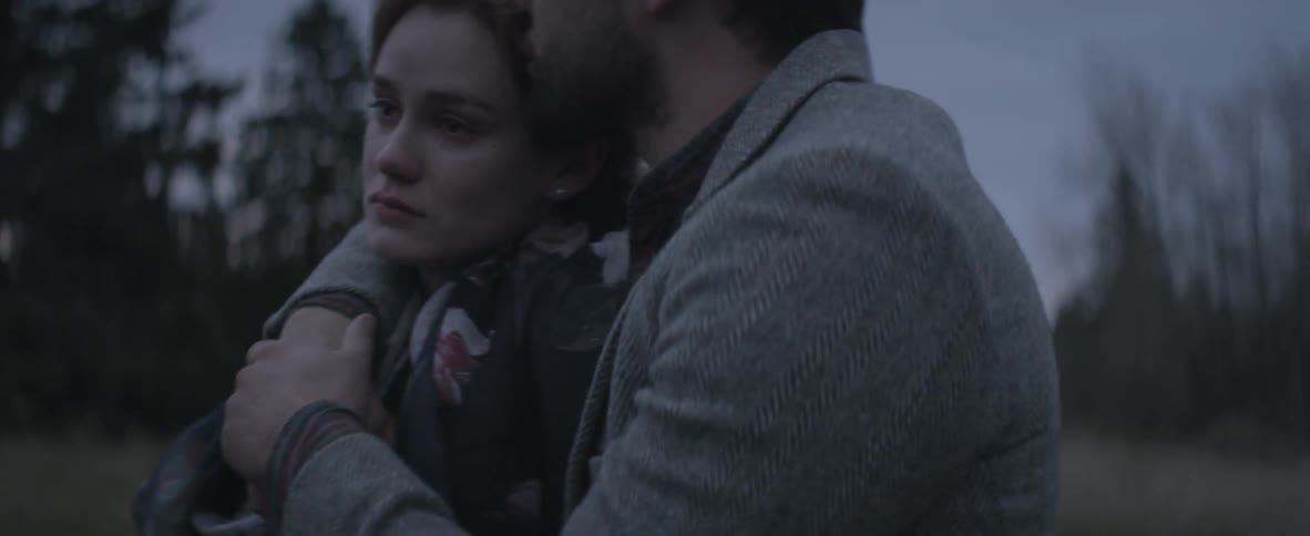 A man putting his arm around a distraught woman