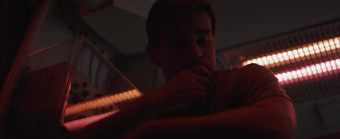 Man puts his hand on his face at night