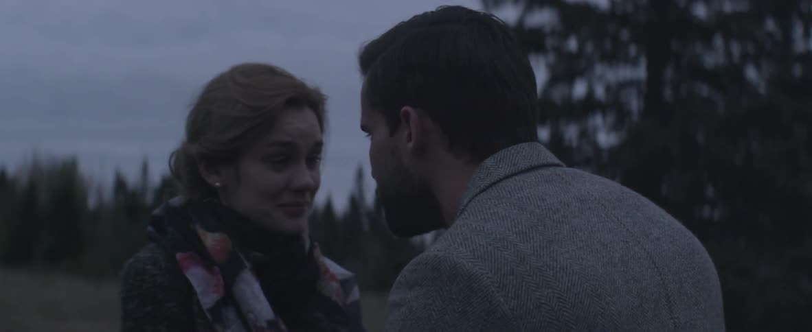 Woman talks with a man outside on a cloudy day