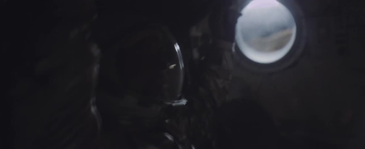 Man wearing large helmet raising his arms and shaking