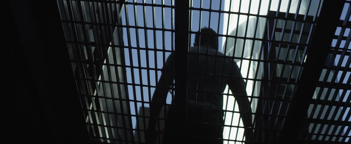 A person walking on top of a grate