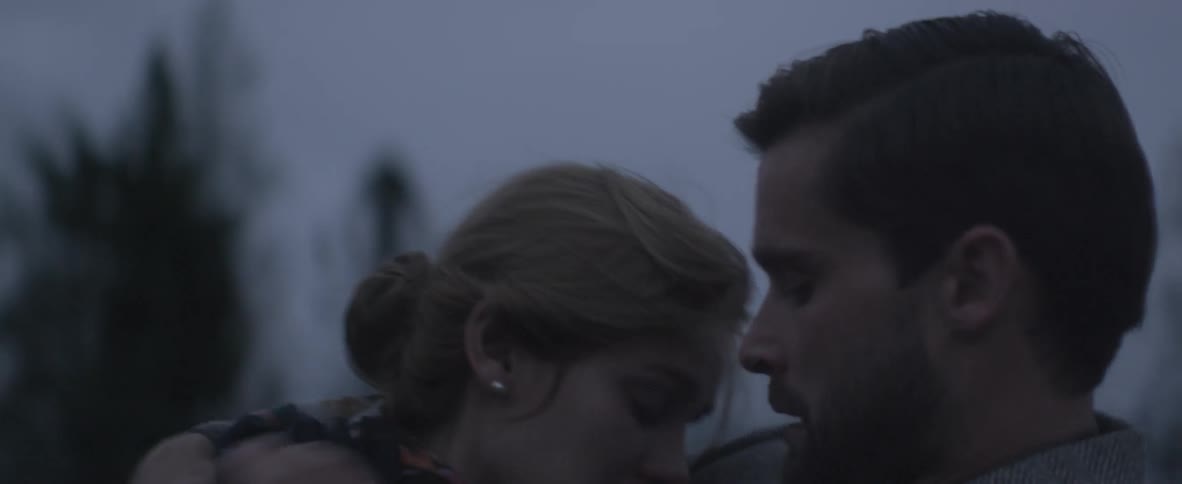 Man kisses a woman and hugs her