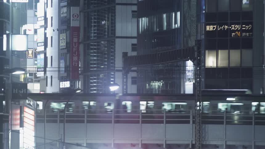 A train travels next to the buildings in the city