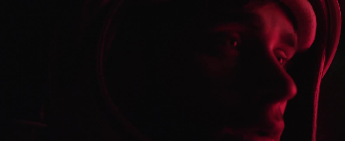 Red light reflecting on peoples faces