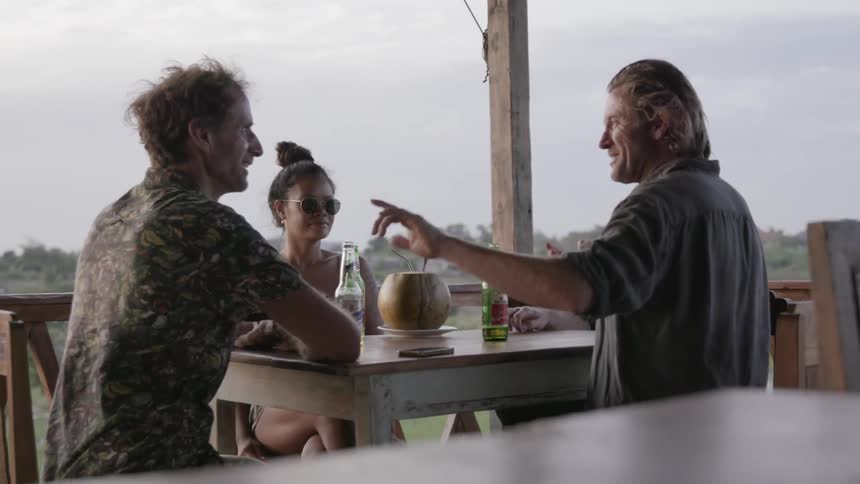 People talk and drink on a patio