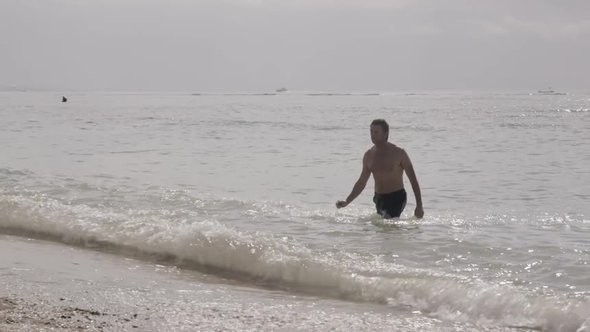 A man swims in the ocean