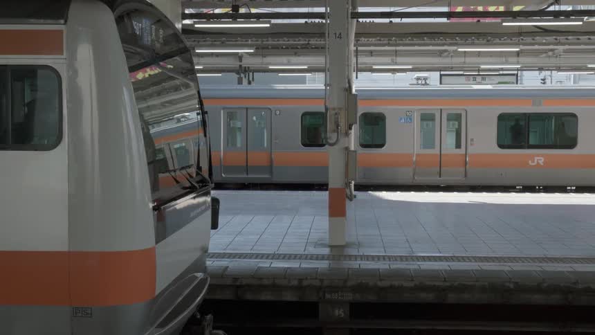 A train conductor walks outside of a subway train