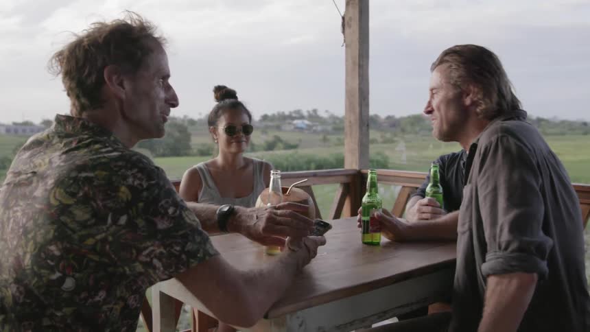 A group of people drink together outside