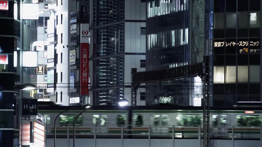 Train passes through a city at night
