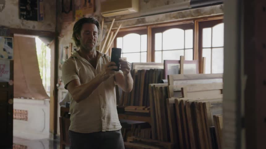 A man takes a photograph in the room