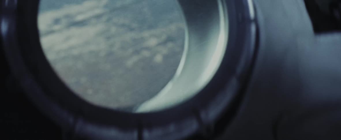 A meteor crosses the earth atmosphere seen through the window of a spaceship